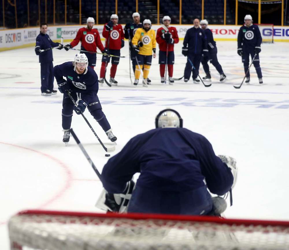 TREVOR HAGAN / WINNIPEG FREE PRESS
Winnipeg Jets' Kyle Connor (81) during a breakaway drill on goaltender Michael Hutchinson (34) during practice at Bridgestone Arena, in Nashville on Saturday.