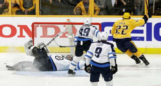 Mark Humphrey / The Associated PressKevin Fiala celebrates after scoring the winning goal against Connor Hellebuyck during the second overtime in Game 2 of the teams' second-round series. The Nashville Predators beat the Winnipeg Jets 5-4.