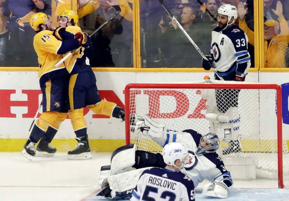 (AP Photo/Mark Humphrey)
Nashville Predators Kevin Fiala, second from left, celebrates with Craig Smith after Fiala scored the game-winning goal during the second overtime in Game 2 of their second-round playoff series, Sunday in Nashville.