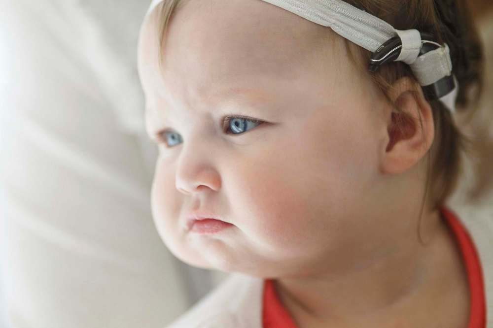 MIKE DEAL / WINNIPEG FREE PRESSIreland Gault, 13 months, has paved the way for more Manitobans younger than one year of age to receive cochlear implants. Early intervention on hearing issues is tied to improved development in speech and language.