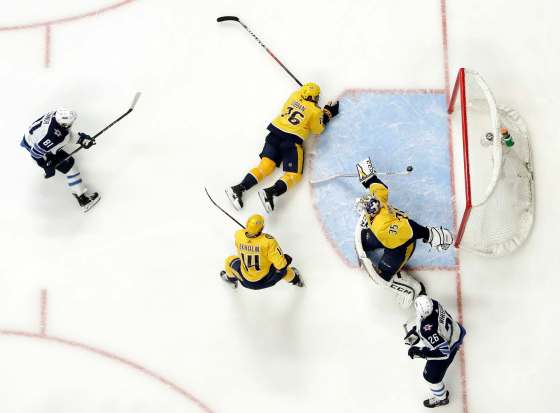 Winnipeg Jets left wing Kyle Connor (81) scores a goal against Nashville Predators goalie Pekka Rinne (35), of Finland, during the second period in Game 5 of an NHL hockey second-round playoff series Saturday, May 5, 2018, in Nashville, Tenn. Also defending for the Predators are Mattias Ekholm (14), of Sweden, and P.K. Subban (76). (AP Photo/Mark Humphrey)
