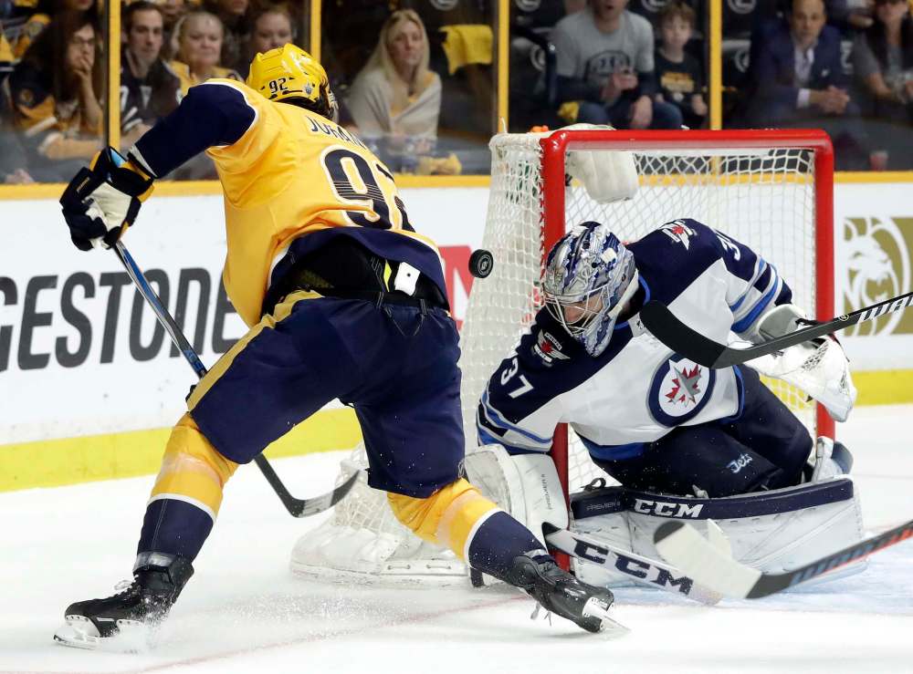 Winnipeg Jets goalie Connor Hellebuyck (37) blocks a shot by Nashville Predators center Ryan Johansen (92) during the second period in Game 5 of an NHL hockey second-round playoff series Saturday, May 5, 2018, in Nashville, Tenn. (AP Photo/Mark Humphrey)