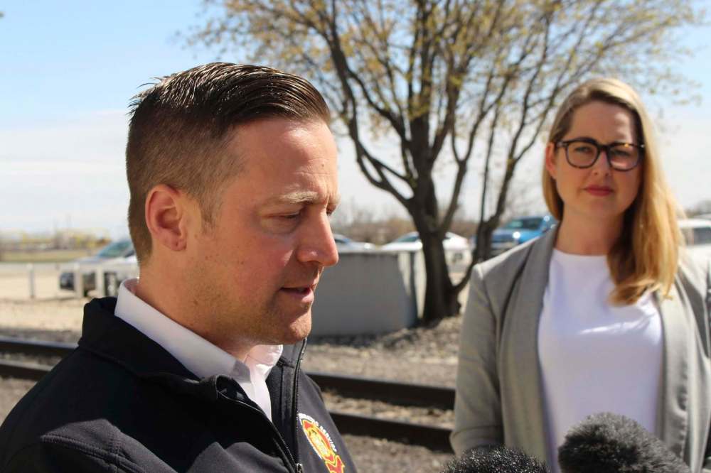 RYAN THORPE / WINNIPEG FREE PRESS
Tom Wallace, WFPS deputy chief, speaks to reporters Wednesday, following a meeting with the Canadian National Railway about a recent spate of brush fires in Winnipeg - some of which were sparked near train tracks. In background: Kate Fenske, spokeswoman for CNR.