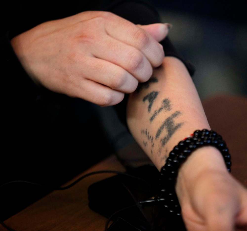 PHIL HOSSACK / WINNIPEG FREE PRESS
Faeza Mejo was forced to tattoo her own arm with the name of her