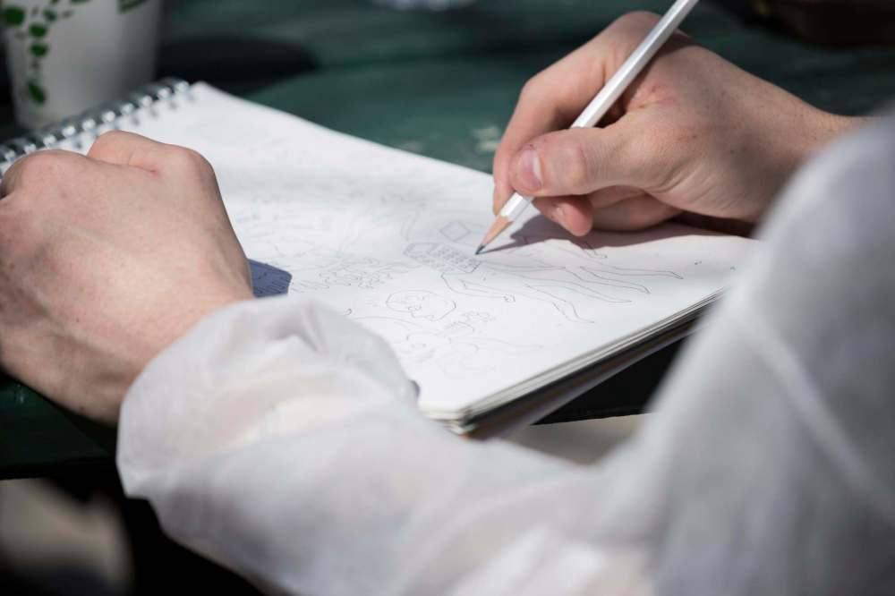 Lindsay Reid photo
Performer and artist Keegan Steele at work on his illustration.