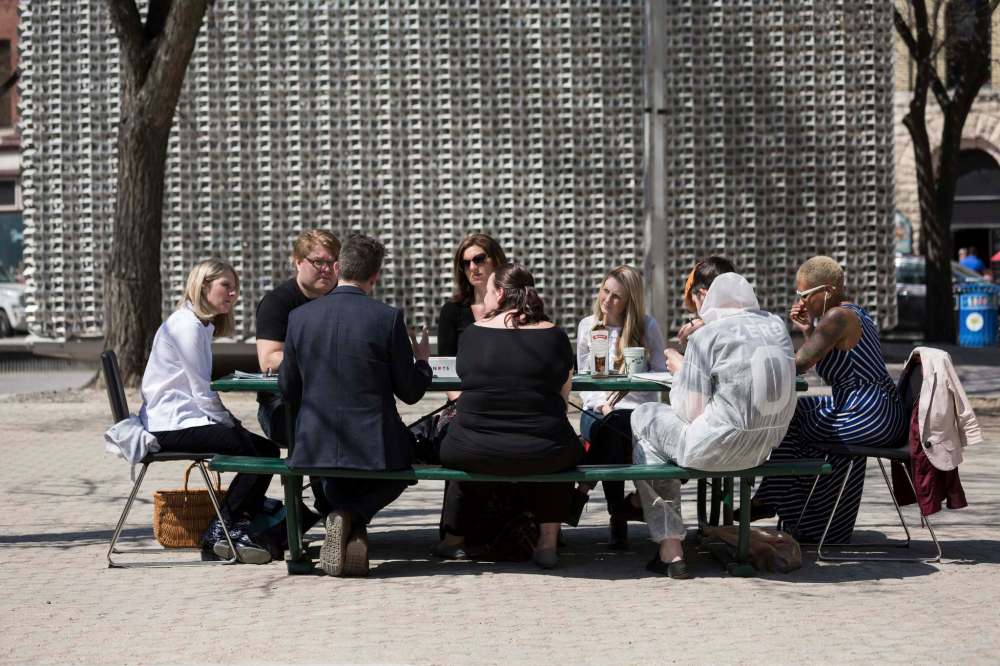 Lindsay Reid photo
Panel members discuss urban and rural public stages and performance spaces at a picnic table in front of the Cube in Old Market Square.