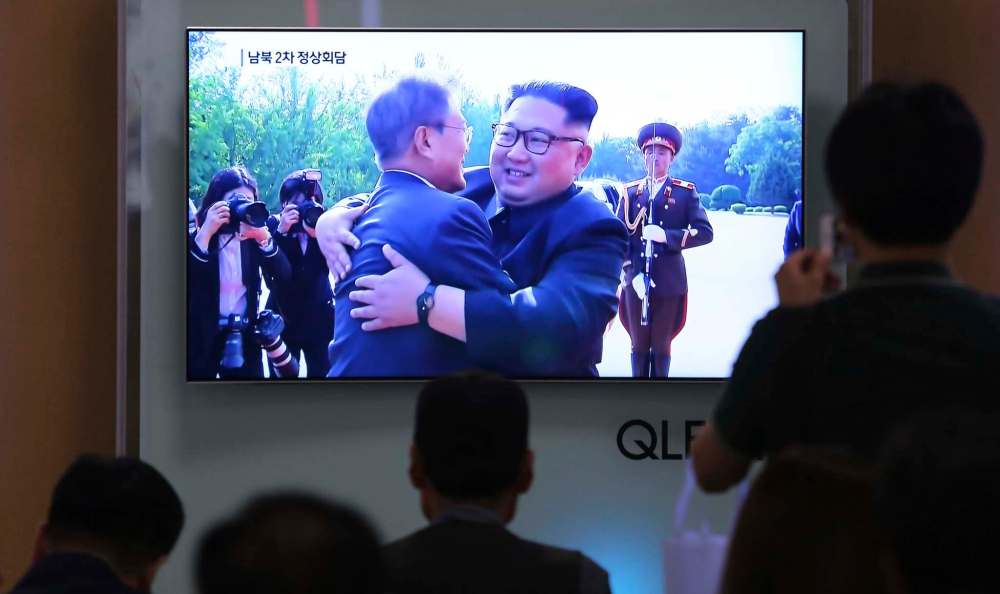 Ahn Young-joon / The Associated Press
People watch a TV screen showing South Korean President Moon Jae-in, left, meets with North Korean leader Kim Jong Un at the border village of Panmunjom during a news program at the Seoul Railway Station in Seoul, South Korea, Saturday, May 26, 2018. Kim and Moon met for the second time in a month on Saturday to discuss carrying out the peace commitments they reached in their first summit and Kim's potential meeting with President Donald Trump, Moon's office said.