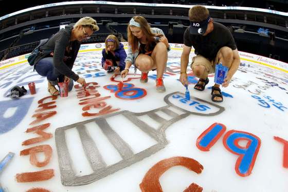 JOHN WOODS / WINNIPEG FREE PRESSTannis St. Louis (from left) and her children, Raelle and Piper, and her husband, Justin, paint the ice at Bell MTS Place Sunday.