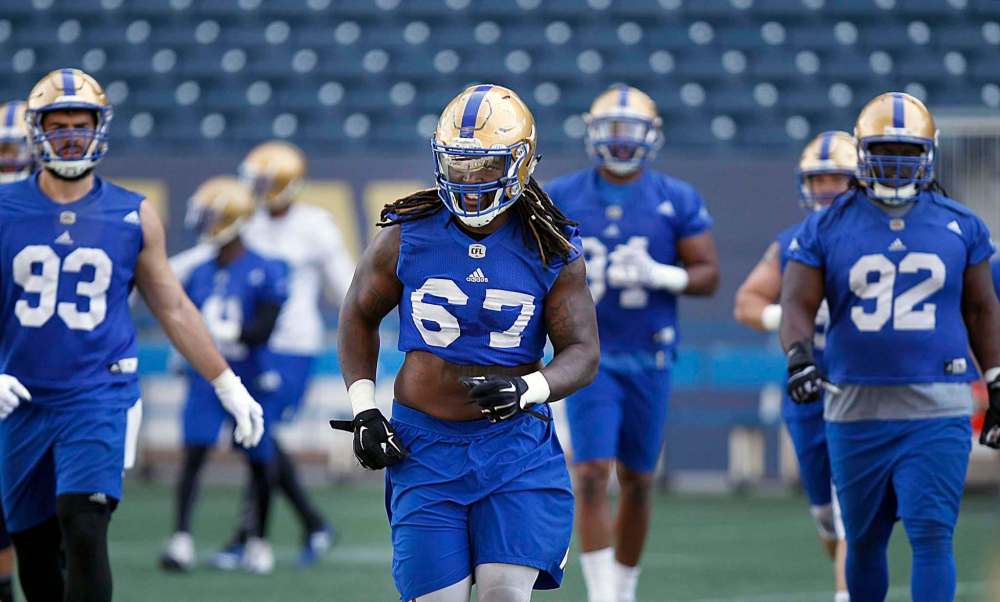 PHIL HOSSACK / WINNIPEG FREE PRESS
The Winnipeg Blue Bombers’ Cory Johnson (centre) participates in a team workout on Monday. The defensive tackle believes he can become a game-changing force during his second season with the team.