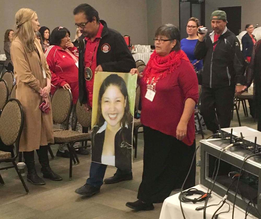Steve Lambert / The Canadian Press files
Bernice Catcheway, right, carries a picture of her daughter, Jennifer Catcheway, into a hearing of the national inquiry into missing and murdered women in Winnipeg on Friday Oct. 20, 2017.