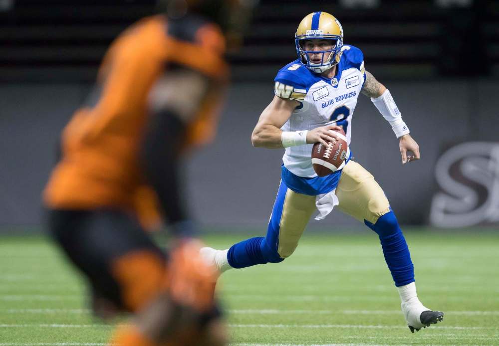 THE CANADIAN PRESS/Darryl Dyck
Winnipeg Blue Bombers quarterback Bryan Bennett runs with the ball before completing a pass to Rueben Randle for a touchdown, during the first half of a pre-season CFL football game against the B.C. Lions in Vancouver, on Friday June 8, 2018.