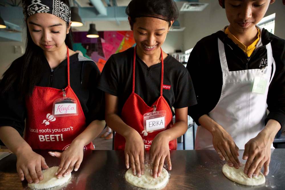 Umali, left, Yazon, centre, and Hinsunarin practice kneading pizza dough.