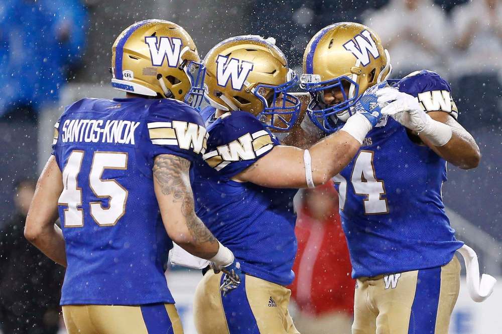 THE CANADIAN PRESS/John Woods
Winnipeg Blue Bombers' Jovan Santos-Knox (45), Adam Bighill (4) and Jackson Jeffcoat (94) celebrate a sack against the Edmonton Eskimos during the first half of CFL action in Winnipeg Thursday, June 14, 2018.
