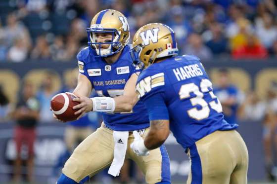 THE CANADIAN PRESS/John WoodsWinnipeg Blue Bombers quarterback Chris Streveler, left, hands off to Andrew Harris against the Edmonton Eskimos during the first half of CFL action in Winnipeg Thursday, June 14, 2018.