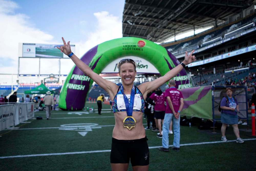 ANDREW RYAN / WINNIPEG FREE PRESS
Women's winner Amy Feit after she crossed the finish line with a total time of 03:02:50.