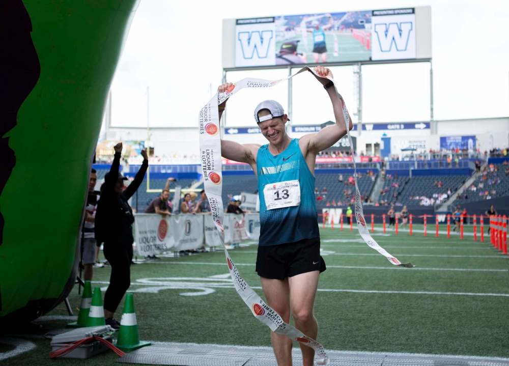 ANDREW RYAN / WINNIPEG FREE PRESS
Men's marathon winner Corey Gallagher crosses the finish in 02:37:47.