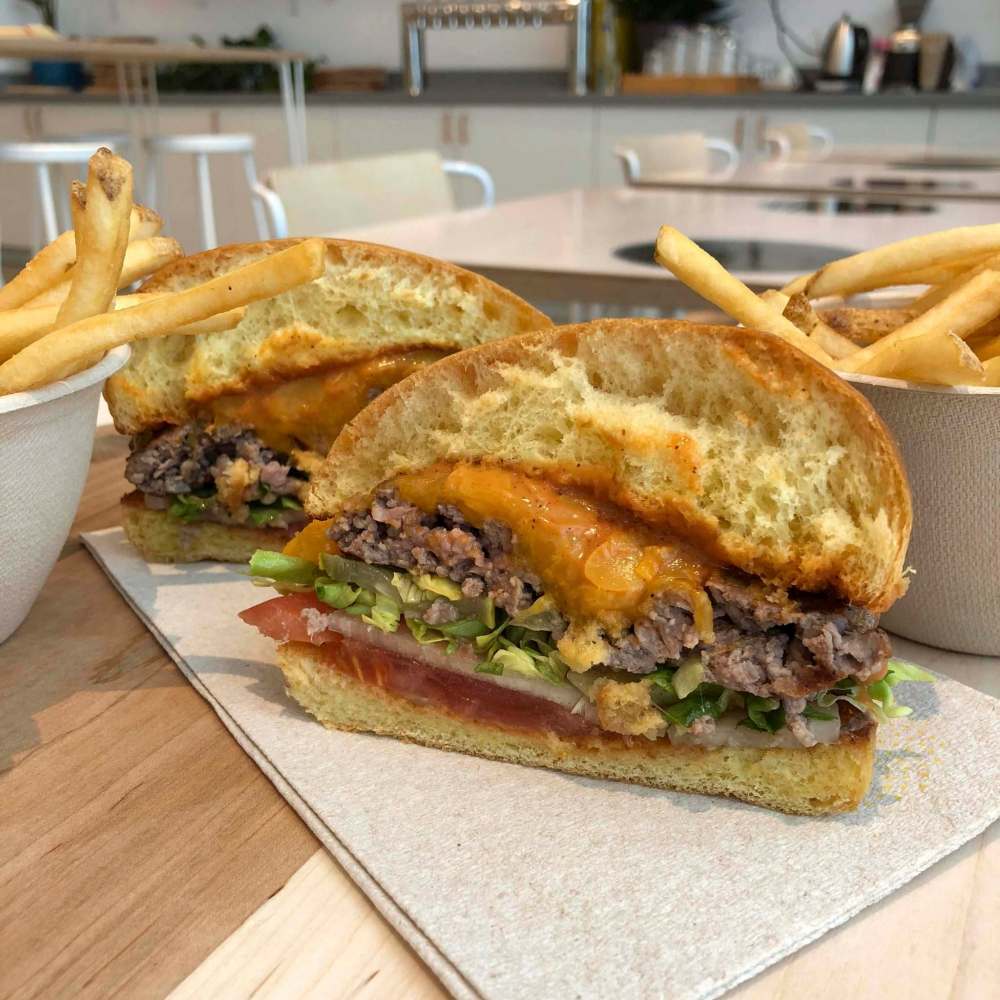 A burger and fried are arranged for a photograph at the Creator storefront in San Francisco, California, U.S., on Monday, June 18, 2018. On June 27, the world’s first robot-crafted burger will roll off a conveyor belt in San Francisco and into the hands of the public. The product, from Bay Area-based Creator, a culinary robotics company, is assembled and cooked in a machine that contains 20 computers, 350 sensors, and 50 actuator mechanisms. Photographer: Kate Krader/Bloomberg