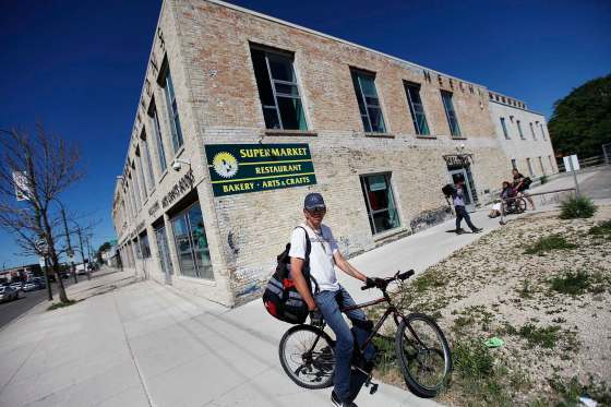 PHIL HOSSACK / WINNIPEG FREE PRESSRidong his bike in for supplies, Warren Catcheway was taken by suprise Thursday as he and other customers found out the doors close Saturday at Neechi Commons.