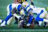THE CANADIAN PRESS/Peter Power
Hamilton Tiger-Cats running back Sean Thomas Erlington, bottom, gets to the one yard line while being tackled by Winnipeg Blue Bombers defensive tackle Cory Johnson, left, and defensive back Marcus Sayles during first quarter in Hamilton, on Friday.