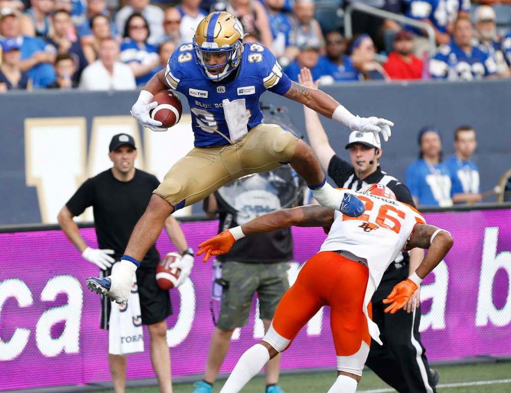 John Woods / The Canadian Press files
Bombers tailback Andrew Harris can leap defenders, in this case B.C.’s Anthony Orange, in a single bound. But it won’t keep Winnipeg from spreading the ball around on offence.