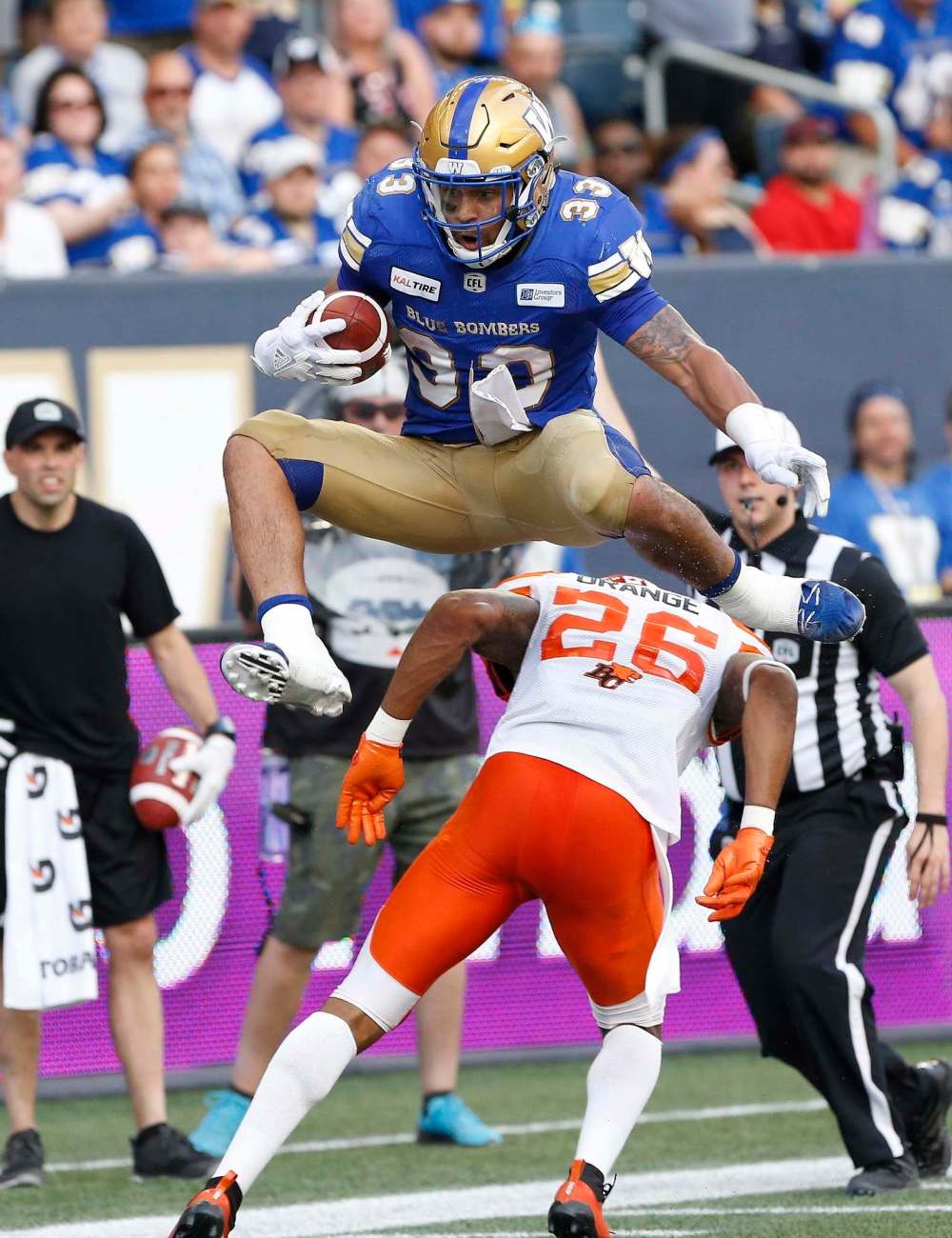JOHN WOODS / THE CANADIAN PRESS FILES
Winnipeg Blue Bombers' Andrew Harris (33) leaps over BC Lions' Anthony Orange (26) during the first half of CFL action in Winnipeg Saturday, July 7, 2018.