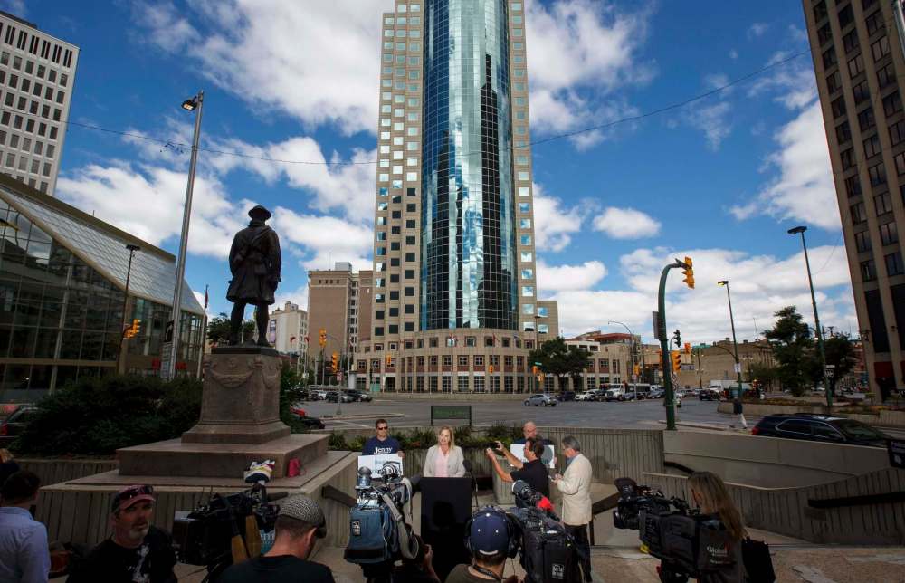 Jenny Motkaluk holds a press conference in front of the Bank of Montreal building at Portage and Main as part of her campaign against re-opening the intersection. (Mike Deal / Winnipeg Free Press)