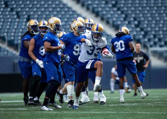 ANDREW RYAN / WINNIPEG FREE PRESSIt may be the dying moments of a gruelling, 167-yard game, but Andrew Harris (33, at practice Tuesday) still takes the ball ‘with force and goes and runs over two more people,’ says his quarterback, Matt Nichols.