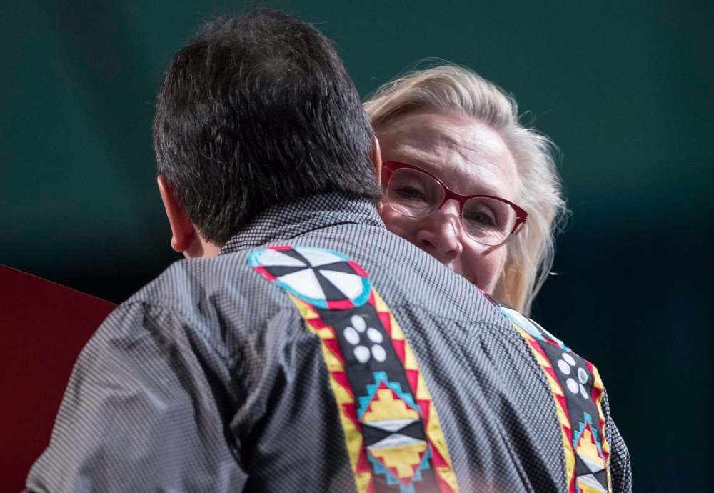 Minister of Crown-Indigenous Relations Carolyn Bennett and Assembly of First Nations National Chief Perry Bellegarde embrace at the AFN annual general assembly in Vancouver on Thursday. Bellegarde has been criticized as being too close to the Liberals. (Darryl Dyck / The Canadian Press)