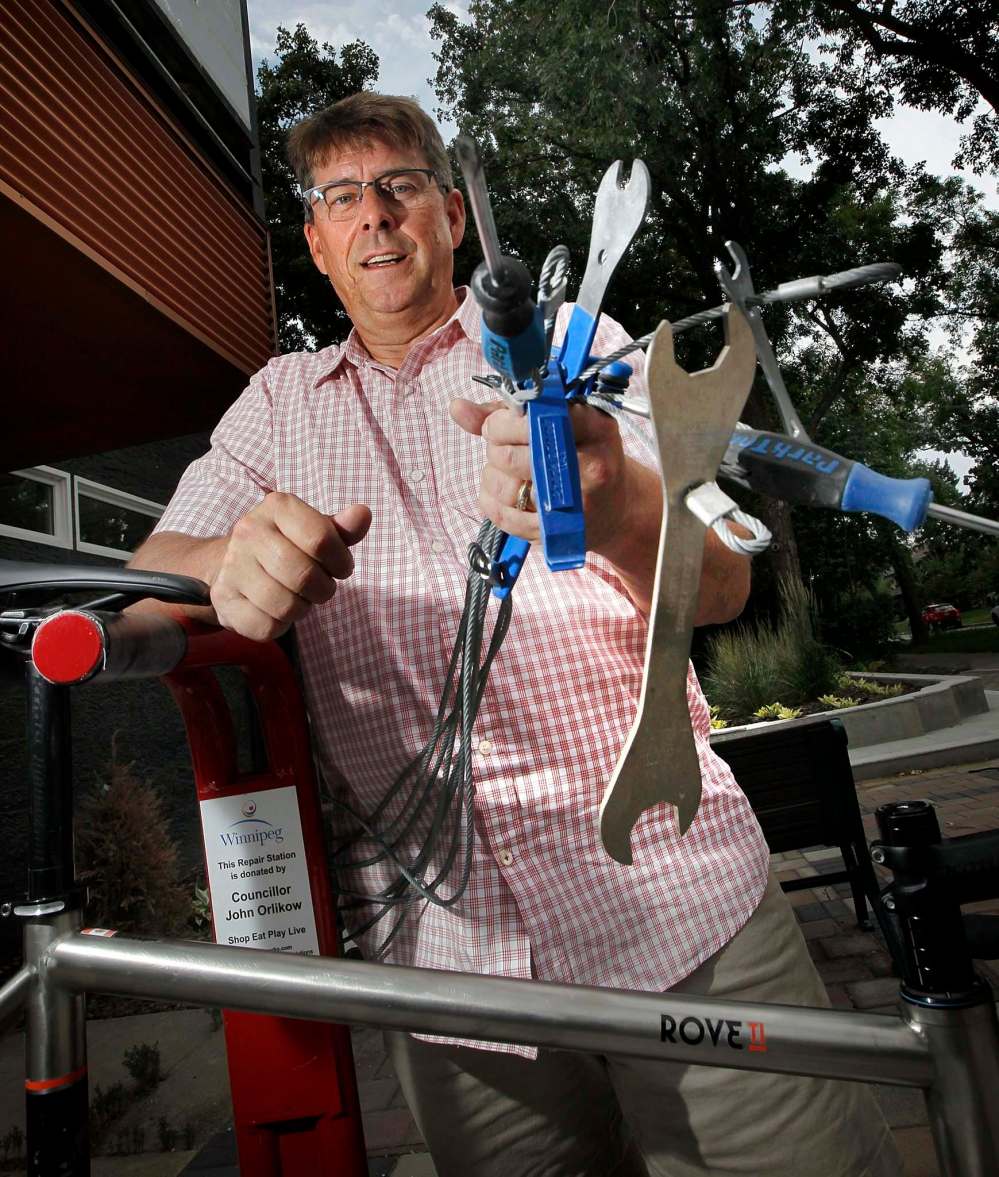 PHIL HOSSACK / WINNIPEG FREE PRESS
Currie Gillespie displays one of the new bike repair stations on Acadamy Rd. at Ash St.