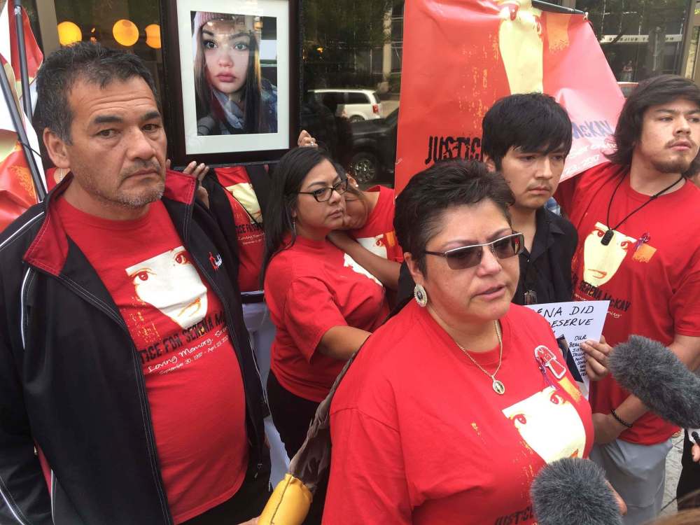 Steve Lambert
/ The Canadian Press
Roland Mousseau (left) and Delores Daniels (middle-right) speak to reporters after a youth was sentenced in the beating death of Daniels' daughter, Serena McKay, on the Sagkeeng First nation, in Winnipeg on Thursday, August 2, 2018. Mousseau, who was the victim's stepfather, erupted in court and shouted that the youth sentence given out Thursday was not nearly enough.