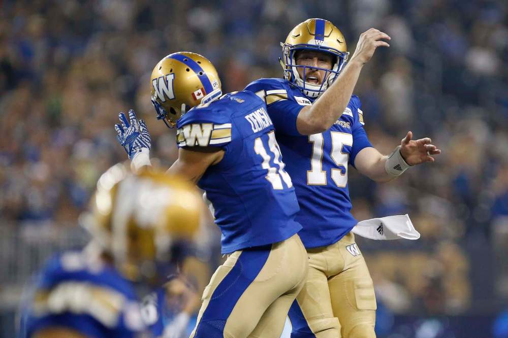 JOHN WOODS / THE CANADIAN PRESS
Bombers Nic Demski (left) and Matt Nichols celebrate Demski’s second-half touchdown against Hamilton on Friday night.