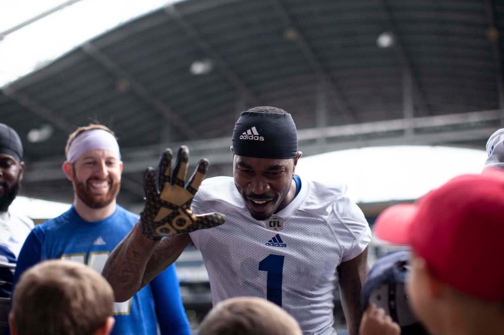 ANDREW RYAN / WINNIPEG FREE PRESS Darvin Adams (1) reaches for a high five from young fans after practice at Investors Group Field on August 14, 2018.