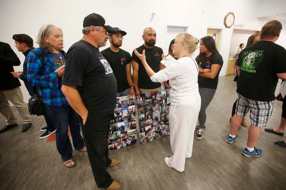 JOHN WOODS / WINNIPEG FREE PRESS
A woman against a new addictions centre in St. James talks with the family of Gabriel Pereira.