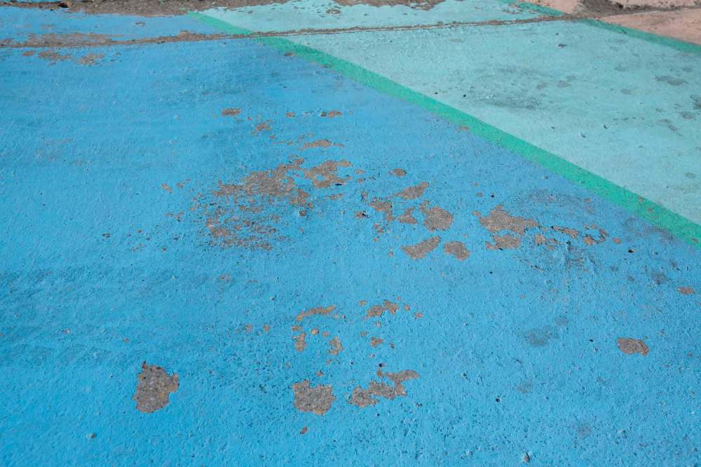 The protected bike lanes in the Exchange District have yet to open for cyclists, but the artistic paint jobs are already flaking away. (Mike Deal / Winnipeg Free Press)