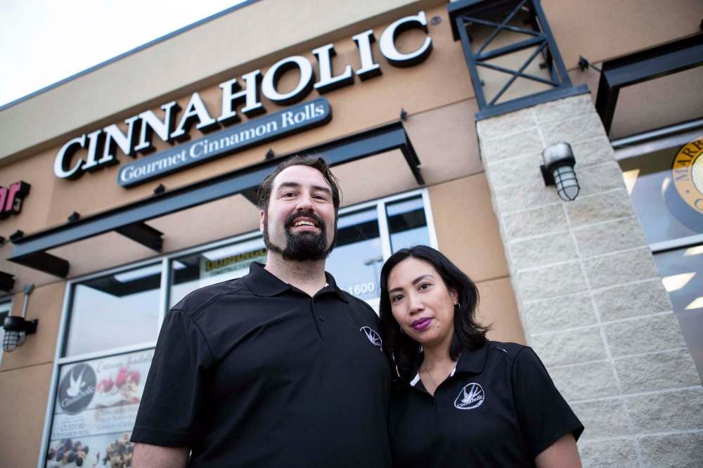 ANDREW RYAN / WINNIPEG FREE PRESS
Colin and Menchie Finlay stand in front of the Kenaston Common storefront for Cinnaholic, which is slated to open in mid-Septembber.
