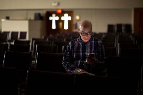 ANDREW RYAN / WINNIPEG FREE PRESS
Media studies professor Nicholas Greco, seen in a chapel at Providence University College in Otterburne, has committed himself to condensing and tweeting out three articles of the Catholic cathecism daily.