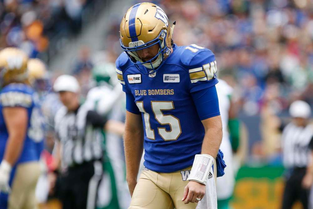 Quarterback Matt Nichols walks off the field after throwing one of two interceptions returned for touchdowns in the second quarter of the 15th annual Banjo Bowl in Winnipeg Saturday. (John Woods / The Canadian Press)