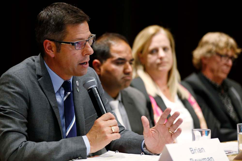 JOHN WOODS / WINNIPEG FREE PRESS
Mayoral candidates Umar Hayat, Jennifer Motkaluk and Doug Wilson listen as mayor Brian Bowman speaks during a mayoral debate at the University of Winnipeg, Tuesday evening.