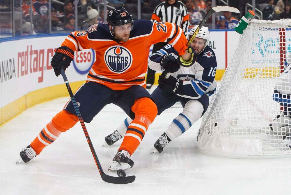 THE CANADIAN PRESS/Jason Franson
Winnipeg Jets' Seth Griffith chases Edmonton Oilers' Leon Draisaitl during second period pre-season action in Edmonton on Thursday.