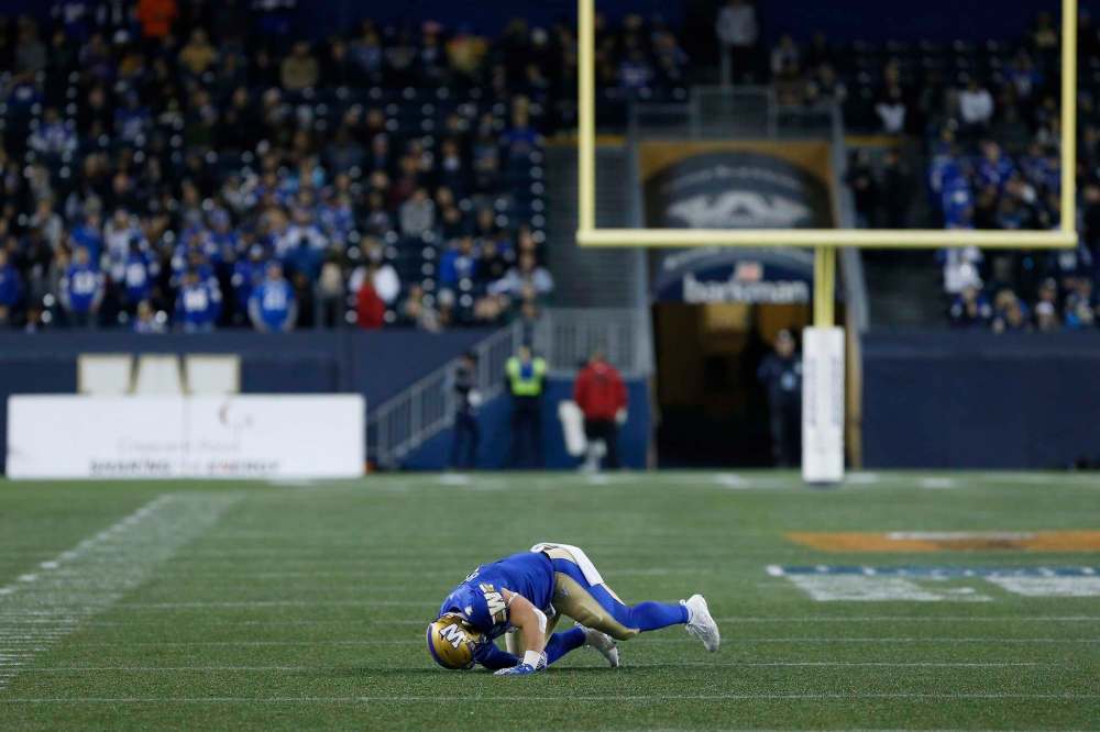 THE CANADIAN PRESS/John Woods
Winnipeg Blue Bombers' Adam Bighill goes down injured against the Montreal Alouettes during the second half in Winnipeg Friday.