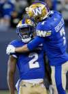 JOHN WOODS / THE CANADIAN PRESS FILES
Kenbrell Thompkins (left) and Weston Dressler celebrate one of Thompkins’ five catches in Friday’s win.