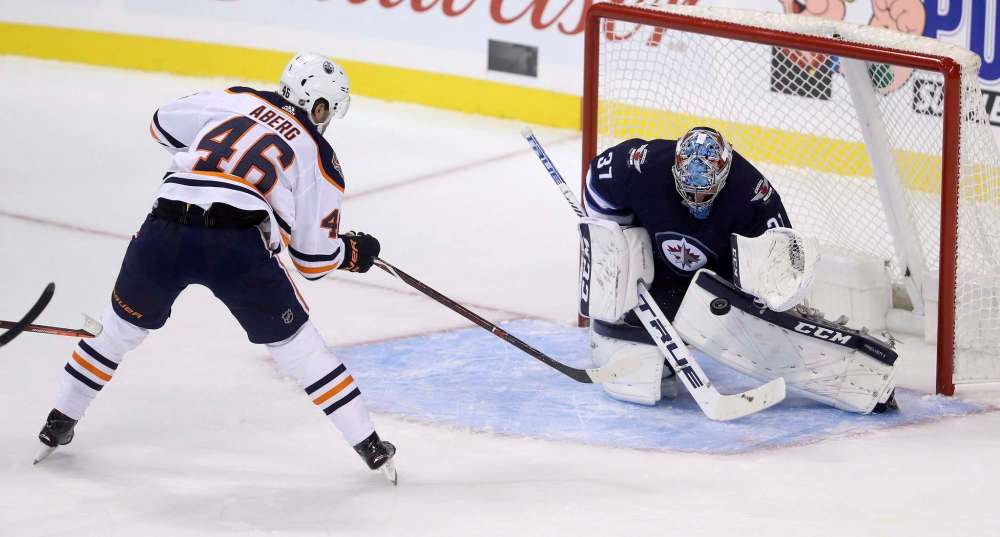 TREVOR HAGAN / THE CANADIAN PRESS
Winnipeg Jets' goaltender Connor Hellebuyck (37) stops Edmonton Oilers' Pontus Aberg (46) on a breakaway during first period preseason NHL hockey action in Winnipeg, Sunday, September 23, 2018.