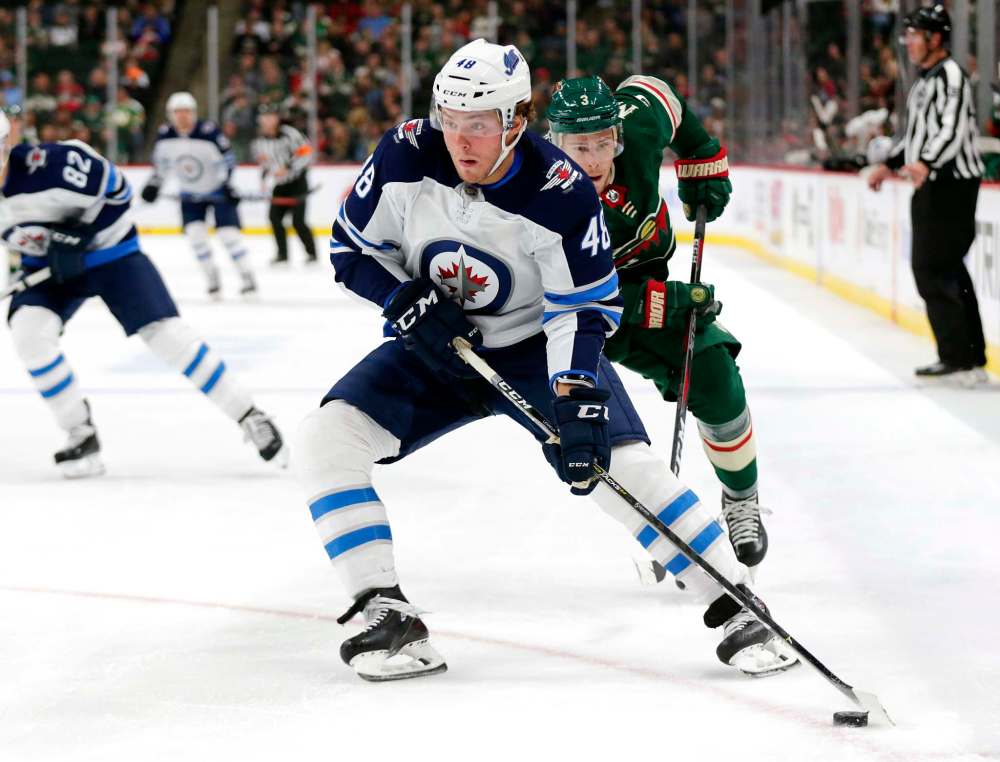 AP Photo/Andy Clayton-King
Winnipeg Jets left wing Brendan Lemieux controls the puck in front of Minnesota Wild right wing Charlie Coyle during the first period of a preseason NHL hockey game Wednesday in St. Paul, Minn.