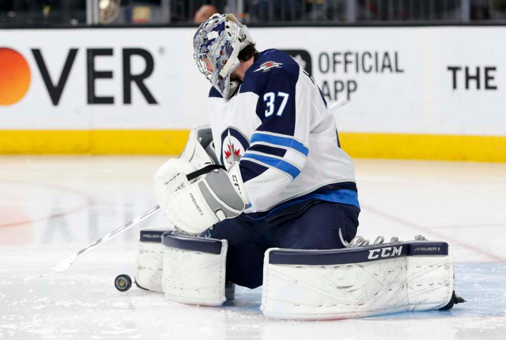 Connor Hellebuyck had a 44-11-9 record last year and will carry a heavy workload this season. His play will be a key factor in how the Jets fare. (John Locher / The Associated Press files)