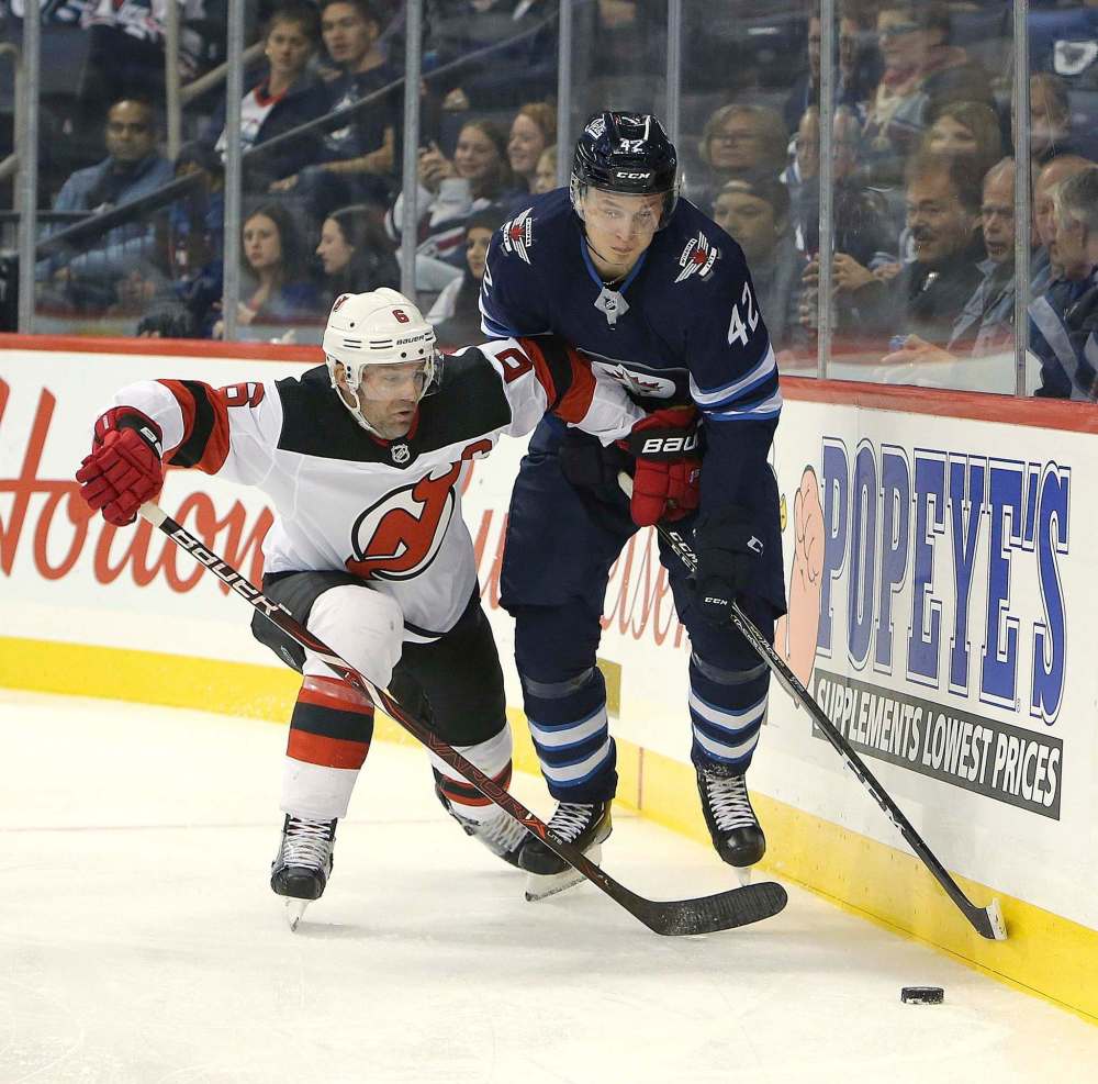 JASON HALSTEAD / THE CANADIAN PRESS FILES
Winnipeg Jets forward Kristian Vesalainen battles New Jersey Devils defenceman Andy Greene during a pre-season game in Winnipeg Sept. 27. Vesalainen earned his first NHL point on a feed to Brandon Tanev against the St. Louis Blues.