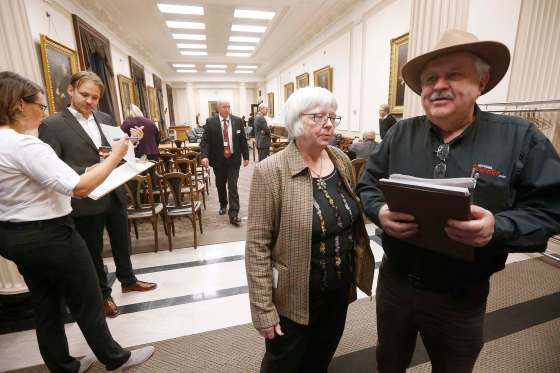 JOHN WOODS / WINNIPEG FREE PRESSChristine and Ken Waddell, owners of Neepawa Banner and Press, express their frustration as other people sign a petition while they wait for a committee meeting to start at the Manitoba Legislature Thursday. Delays by politicians led to the late start for committee meetings.