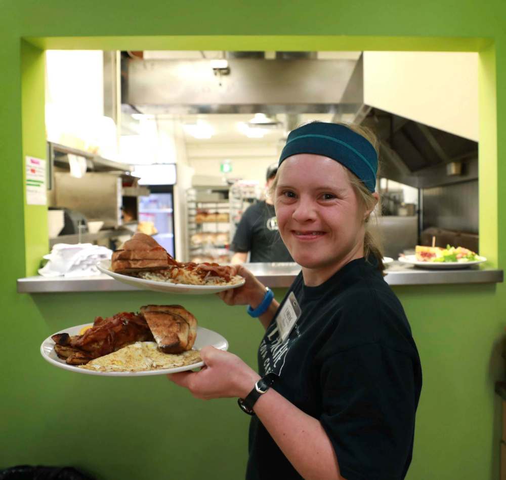 Stacey Friesen picks up a food order from the kitchen.