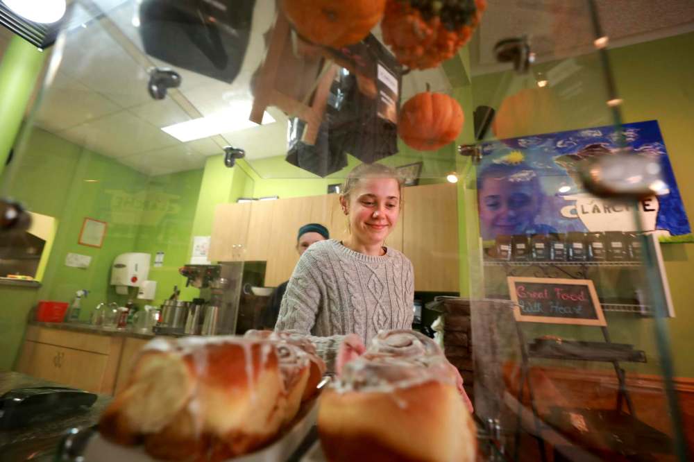 Server Sara Dales gets a homemade cinnamon bun for a customer.