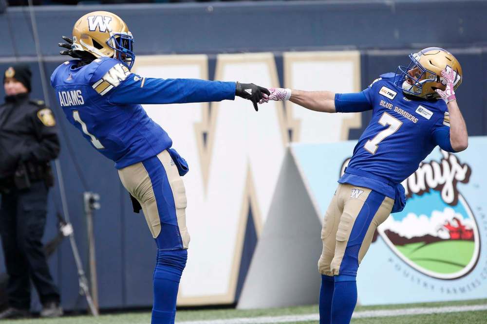 JOHN WOODS / THE CANADIAN PRESS
Darvin Adams and Weston Dressler celebrate Adams' touchdown against the Saskatchewan Roughriders during the first half.