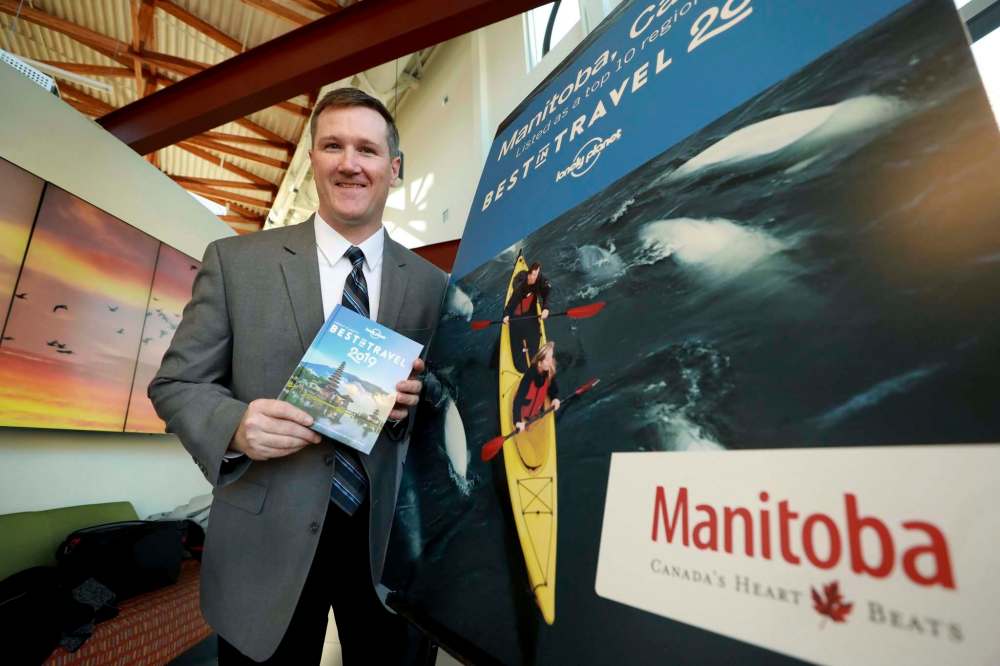 RUTH BONNEVILLE / WINNIPEG FREE PRESS
Ben Buckner, Lonely Planet Canadian Destination Editor, with newly-released edition of lonely planet listing Manitoba as one of the top 10 regions for travel destinations for 2019 at the Forks, Tuesday.